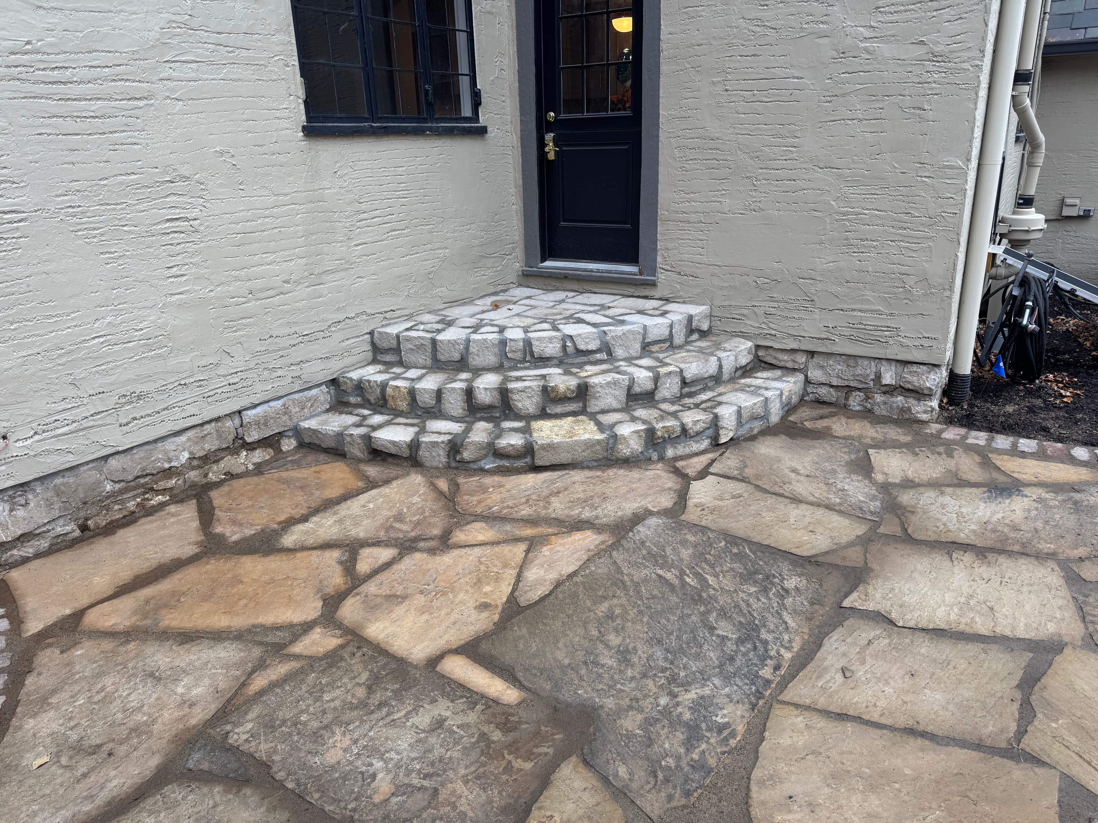 Flagstone patio with curved stone steps
